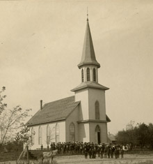 Sepia photo of church with crowd of people in front