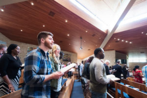 students singing in chapel