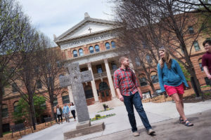 Students talk outside Bockman Hall, one of the on-campus housing options