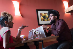 Recent graduates Christine Belfrey Johnson (left) and Joe Davis study at Colossal Cafe in St. Paul, Minnesota