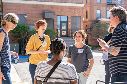 Group of five students talking outside Bockman