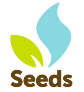 The Seeds Project Logo is a green leaf and blue flame with "Seeds" in brown text beneath