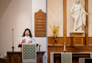 A Luther Seminary student preaches from the pulpit in a Christian sanctuary