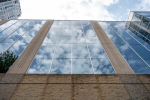 View of clouds reflecting off the River Parkway Place windows