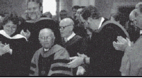 Daniel Simundson (front seated) acknowledges the ovation given to him and Peter Sethre at the 2003 Commencement.