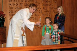 pastor lighting a candle