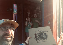 Hans Dahl ‘05 M.Div. delivers pizza to a family participating in an online church gathering.