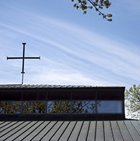 Church building with cross against blue sky