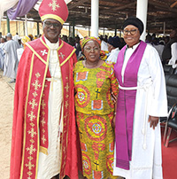 Marie Y. Hayes (center) stands with Archbishop Musa Panti Filibus ’98 Ph.D. (right) and his wife, Ruth Musa Filibus.