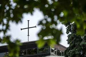 Church building with cross against blue sky