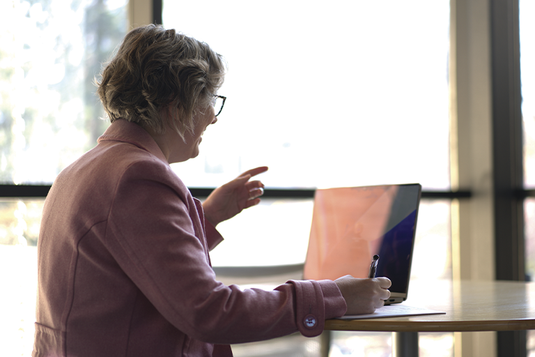 Person sitting in front of a laptop