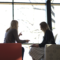 Two people sitting and talking